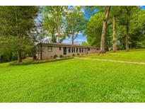 Charming single-story home with a well-maintained lawn and mature trees at 7022 Lakeside Dr, Charlotte, NC 28215