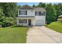Charming two-story home with a welcoming front porch and well-maintained landscaping and long driveway at 8524 Emerald Fern Way, Charlotte, NC 28214