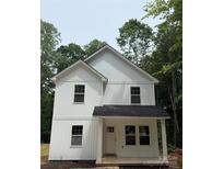 Charming new construction two-story home featuring white siding and a welcoming front porch in a wooded neighborhood at 1723 Rhyneland Cir, Gastonia, NC 28054