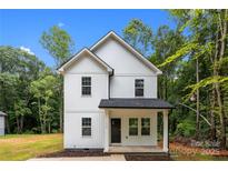 Charming two-story home with white vertical siding, black roof, and inviting front porch at 1723 Rhyneland Cir, Gastonia, NC 28054