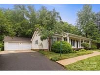 Charming home featuring a detached two-car garage and a well-maintained front yard at 1821 Bonnie Ln, Charlotte, NC 28213