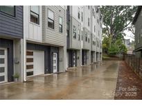 A row of modern townhomes featuring individual garages and contemporary design, set in a desirable neighborhood at 2011 Hamorton Pl, Charlotte, NC 28205