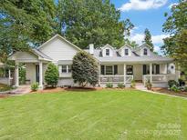 Charming white-painted brick home with a welcoming front porch and lush green lawn at 2112 Chatham Ave, Charlotte, NC 28205