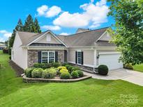 Charming single-story home with stone accents, manicured lawn, and attached two-car garage at 2213 Hartwell Ln # 84, Indian Land, SC 29707