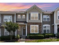 Charming townhome exterior with stone accents, tidy landscaping, and a welcoming entrance at 230 Dawn Mist Ln, Fort Mill, SC 29708