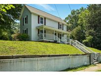 Charming two-story home featuring a welcoming front porch and beautiful lawn at 238 N Depot St, Albemarle, NC 28001
