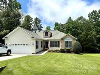 Charming single-story home featuring stone accents, manicured lawn, and attached two-car garage at 3110 Richards Way Dr, Rock Hill, SC 29732