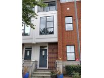 Charming townhome with brick and neutral siding, featuring large windows and a welcoming entrance at 408 N Mcdowell St, Charlotte, NC 28204