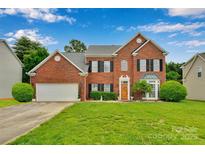 Charming two-story brick home with manicured lawn, attached garage, and inviting front entrance at 508 Whitehead Ct # 328, Fort Mill, SC 29708