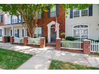 Charming brick townhouse with a well-manicured lawn and a white picket fence at 609 Atherton Way, Rock Hill, SC 29730