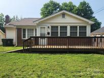 Charming bungalow with brick accents and a wooden front deck perfect for enjoying the outdoors at 76 Sumner Nw Ave, Concord, NC 28027