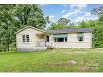 Charming single-story home with a welcoming front porch and lush green lawn at 8334 Oaktree Rd, Sharon, SC 29742