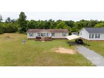 Charming single-Gathering home with a welcoming front porch and a convenient carport at 1007 W Cabaniss Rd, Shelby, NC 28150