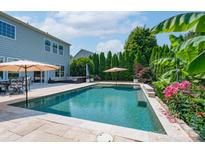 Relaxing backyard oasis with a beautiful in-ground pool, patio, and lush landscaping at 1211 Gold Rush Ct, Fort Mill, SC 29708