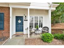 Inviting front porch with seating and a view, enhancing curb appeal with a tranquil ambiance at 125 Lynch Cir, Mooresville, NC 28117
