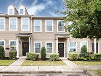 Charming townhome featuring a welcoming entrance with a dark front door and manicured landscaping at 13422 Calloway Glen Dr, Charlotte, NC 28273