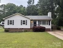 Lovely home with manicured lawn, classic siding, and black shutters enhancing curb appeal and style at 2015 Downey St, Rock Hill, SC 29732