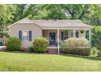 Charming single-story home with a cozy front porch and well-maintained landscaping at 203 Lincoln St, Belmont, NC 28012