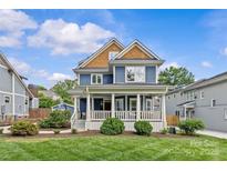 Charming blue two-story home with a large front porch and well-manicured lawn at 2315 Winthrop Ave, Charlotte, NC 28203