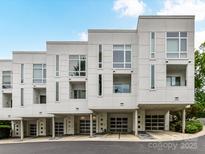 Modern townhome featuring a white exterior, covered parking, and contemporary design at 314 Viburnum Way Ct, Charlotte, NC 28208