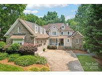Charming two-story home with a well-manicured lawn and brick accents at 3327 Lakeside Dr, Charlotte, NC 28270