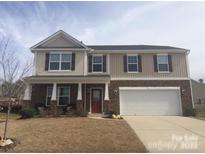Charming two-story home featuring a two-car garage and welcoming front porch at 5008 Social Cir, Fort Mill, SC 29707