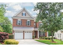 Charming brick two-story home with a manicured front yard and a two car garage at 8115 Wilburn Ct, Charlotte, NC 28277
