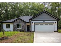 Charming single-story home with stone accents and a two-car garage at 813 Montreat Dr, Dallas, NC 28034