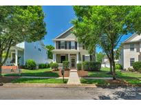 Charming two-story home with a well-manicured front yard, beautiful landscaping, and a welcoming entrance at 9227 Island Overlook Ct, Cornelius, NC 28031