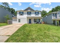 Charming two-story home with blue shutters and well-manicured lawn at 9612 Old Dowd Rd, Charlotte, NC 28214