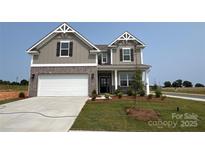 Charming two-story home featuring a brick and gray facade, well-manicured lawn, and a spacious two-car garage at 102 Cartington Way # Haf0042, Mooresville, NC 28115