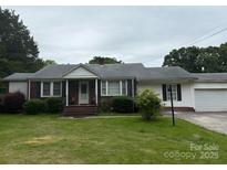 Charming ranch-style home featuring a brick facade, white siding, green lawn, and mature trees at 1292 Longview Rd, Rock Hill, SC 29732