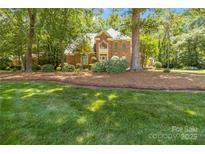 Charming two-story brick home with lush lawn and mature trees at 1520 Cureton Dr, Rock Hill, SC 29732