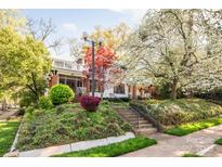 Charming two-story home with landscaped front yard and inviting front porch; perfect for relaxing in a peaceful setting at 1801 E 8Th St, Charlotte, NC 28204