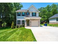 Charming two-story home features a well-manicured lawn, brick accents, and an attached two-car garage, perfect for Gathering living at 2045 13Th Ne St # 3, Hickory, NC 28601