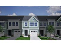 New townhouse with a light-green facade, attached garage, classic black door and beautiful landscaping at 2724 Lehigh Rd, Charlotte, NC 28208
