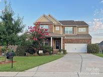Charming brick home with a well-manicured lawn and beautiful landscaping at 3416 Yarmouth Ln, Gastonia, NC 28056