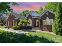 Charming brick home features a well-manicured lawn and a traditional design with black shutters at 3917 Erskine Woods Dr, Bessemer City, NC 28016