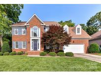 Charming two-story brick home with lush lawn, mature trees, and attached two-car garage at 4637 Shannamara Dr, Matthews, NC 28104