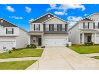 Charming two-story home features a two-car garage, stone accents, and manicured lawn at 5204 Belstone Ln, Charlotte, NC 28215