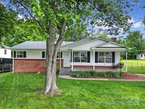Charming single-story home with a well-manicured lawn and a inviting front porch swing at 842 Cherry S Rd, Rock Hill, SC 29732