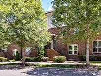 Brick building with lush trees, highlighting the front entrance and well-kept landscaping at 871 Academy St, Charlotte, NC 28205