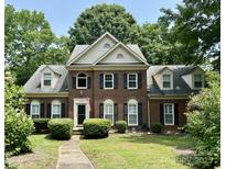 Traditional brick home with manicured lawn, black shutters, and well maintained landscaping at 9900 Colvard Cir, Charlotte, NC 28269