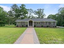 Charming single-story home with a well-manicured lawn and inviting walkway at 120 Pinewood Ln, Rock Hill, SC 29730