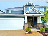 Charming two-story home with a welcoming front porch, manicured lawn, and attached two-car garage at 1230 Therns Ferry Dr, Fort Mill, SC 29708