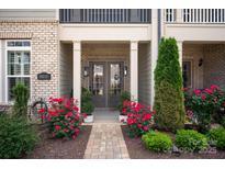 Charming home entrance with brick path, lush landscaping, and covered doorway at 20216 Shaffer Bach Ln, Charlotte, NC 28277