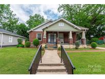 Charming brick home with a covered front porch and well-manicured lawn at 224 E Steele St, Salisbury, NC 28144