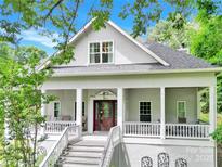 Charming two-story home with a spacious front porch and lush, mature landscaping at 267 Ikerd Se Dr, Concord, NC 28025