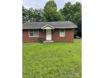 Charming single-story brick home featuring a well-maintained lawn and a classic white front door at 505 N Secrest Ave, Monroe, NC 28110
