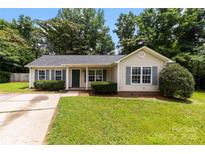 Charming single-story home featuring a well-maintained lawn, matching shutters, and a cozy front porch at 522 Klondike Ln, Charlotte, NC 28216